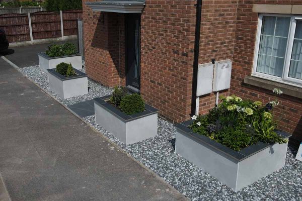 Aerial view of 3 raised flowerbeds clad with Valencia White Compact DesignClad and topped with dark porcelain.***SP Paving, www.sppaving.co.uk
