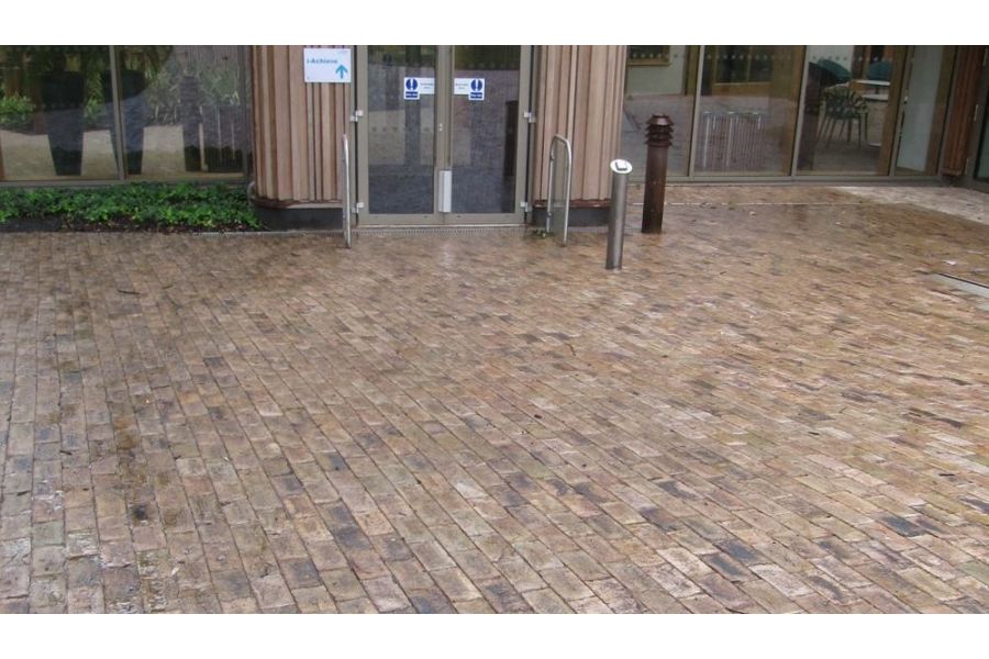 Huge area of walkway that leads to building, uses london mixture clay pavers. Seen wet and showing colour variations