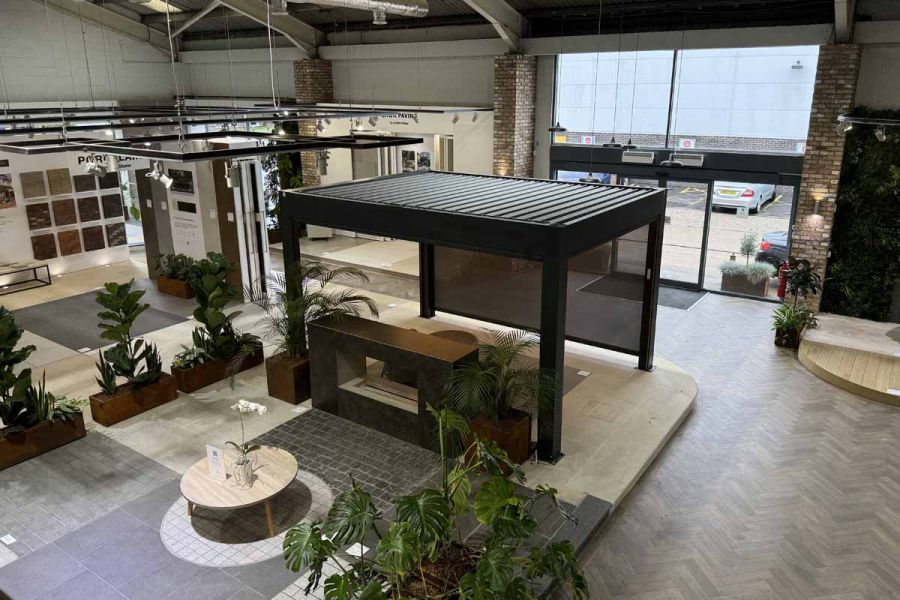 Deluxe Anthracite Grey 4x3 Metal Pergola with blinds shows sleek modern design, in birds eye view of showroom.