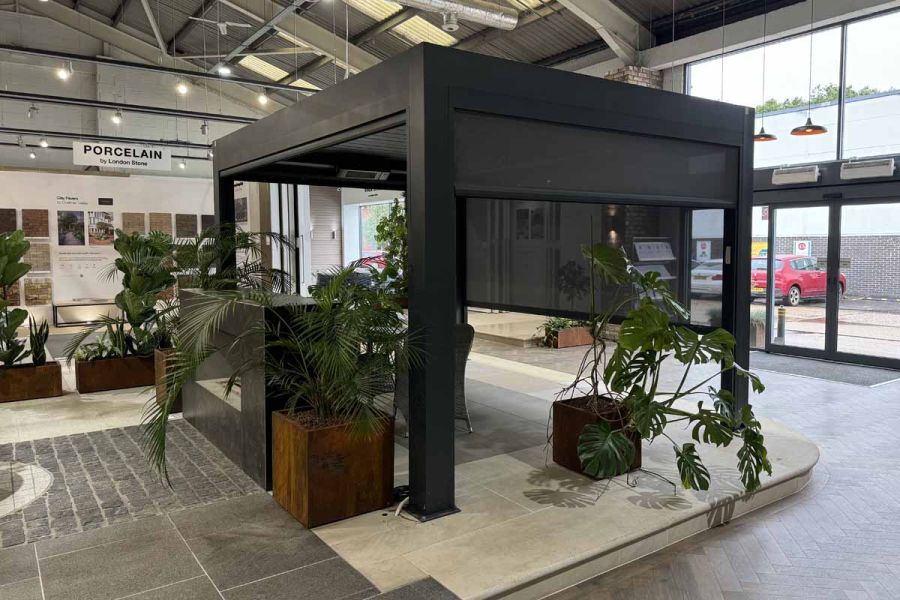 Side view of the Deluxe Anthracite Grey Metal Pergola’s sleek aluminium frame in a showroom, highlighting the durable finish.