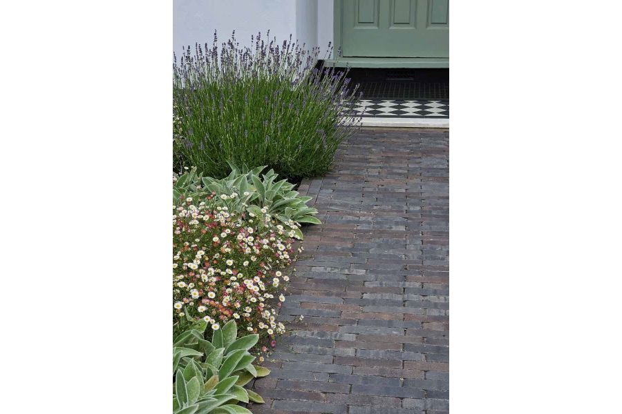 View up path created with Ancona Clay Pavers leads to front door with flowerbed running up the left hand side.