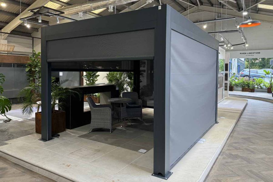 Deluxe Anthracite Grey pergola with adjustable roof louvres and Somfy-controlled blinds for privacy and shade.