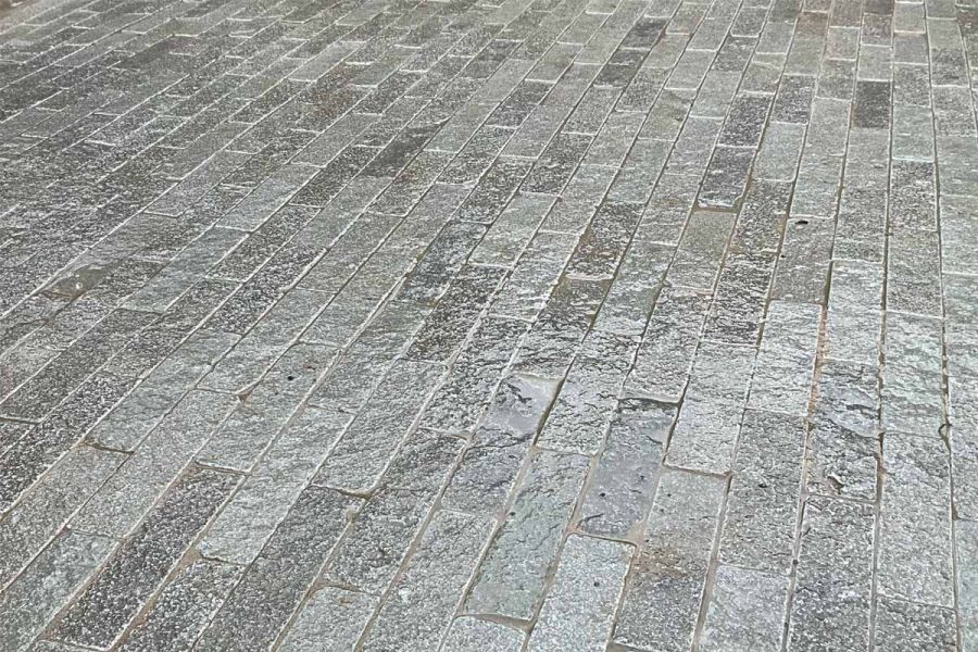 Wet Antique Grey Pavers showcase intricate patterns and subtle variations, adding depth with its different grey tones.