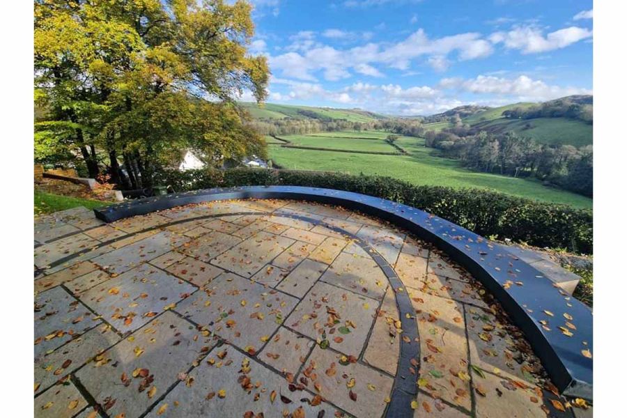 Dan Jury creates peaceful area with glorious countryside views, using antique yellow limestone paving to create a circle.