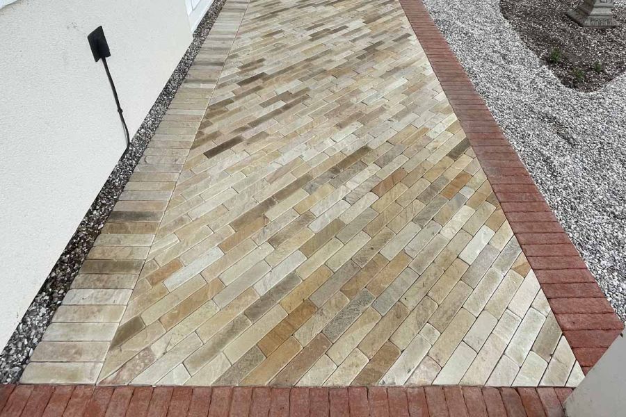 Close-up shot of Tumbled Mint Sandstone pavers used as front entrance steps, edged with red pavers.