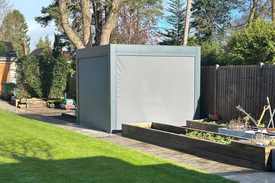 Deluxe Metal Pergola providing full coverage for a dining table, with closed roof louvres and motorised blinds for complete privacy.