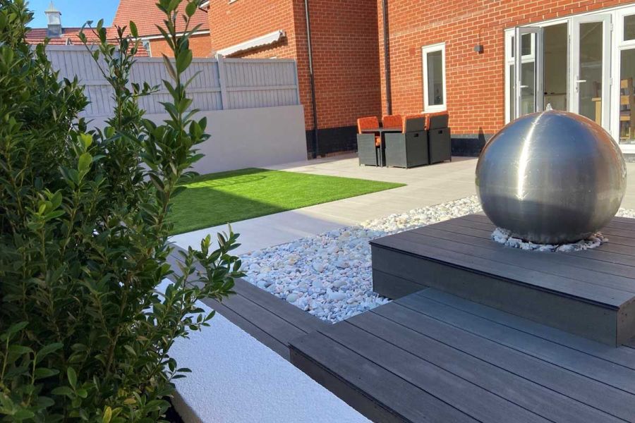 Aerial view from a narrow terrace showcasing Charcoal composite fascia boards alongside porcelain paving and white pebbles.