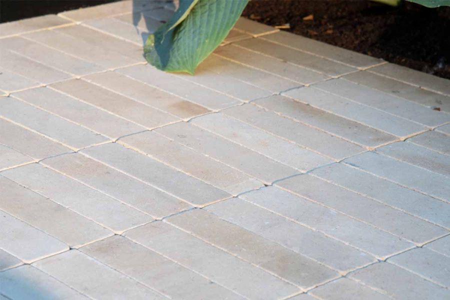 Detailed, angled view of Harvest Sandstone pavers textured surface and the patio bricks pastel colour variations.