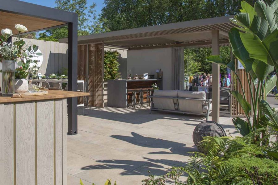 Trade stand at RHS Chelsea by Garden House Design uses Jura Beige Porcelain Paving to exhibit garden furniture.