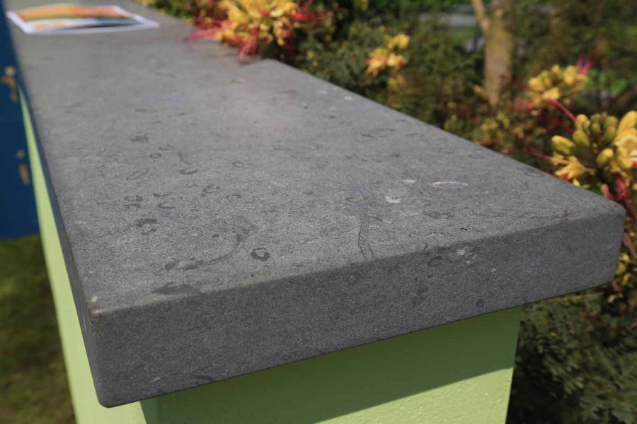 Bespoke crafted Jura Green limestone paving slabs, showcasing unique textures and markings in the stone.