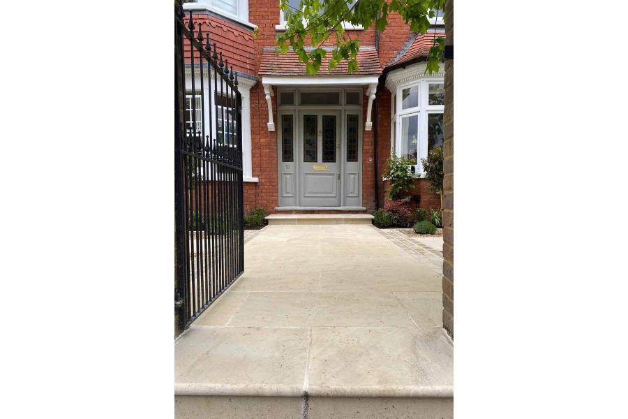Harvest Sawn Sandstone Bullnose Step and matching paving, shows an elegant entrance leading to the front door.