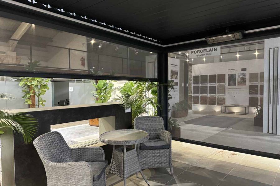 Sleek, modern, deluxe grey metal pergola with adjustable louvres and blinds, offering the perfect balance of sunlight and shade.