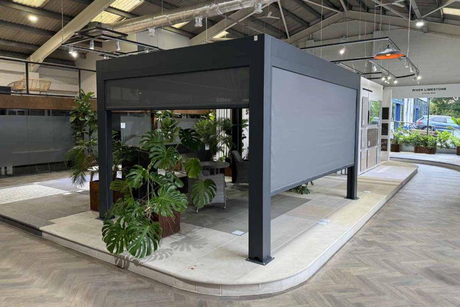 Deluxe Anthracite Grey Metal Pergola with sleek, modern design, installed in London Stone Showroom.