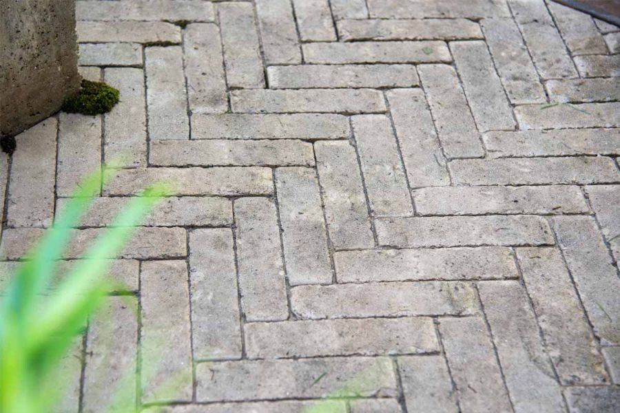 Detailed image of stone grey clay pavers at RHS Chelsea Flower Show 2024, highlighting the subtle hues and rough texture.