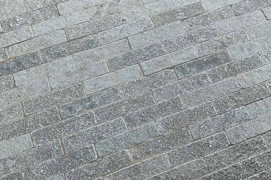 Antique Grey Limestone stone pavers display intricate patterns and nuanced shades of grey in this close up shot.