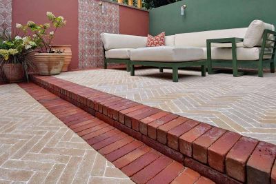 Limestone pavers in herringbone style and seville clay pavers used as border bricks and step up to lounge area.***Katerina Kantalis Garden Design 
