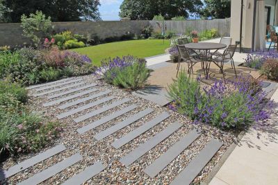 4 Steel Grey porcelain planks with mitred ends form a cross, edging gravel, grass and paving squares. By Aspen Landscape Design.***Aspen Landscape Design & Build,  www.aspenlandscapeglasgow.co.uk