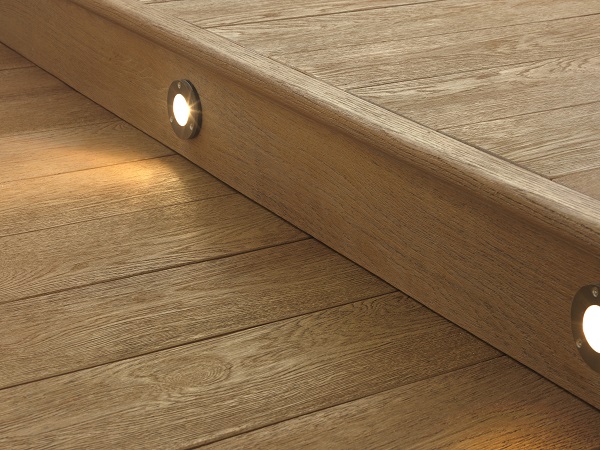 Millboard Coppered Oak decking step with bullnose edge and 2 spotlights in riser.