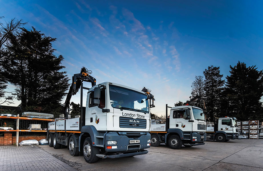 2 London Stone lorries partly loaded, blue sky beyond.