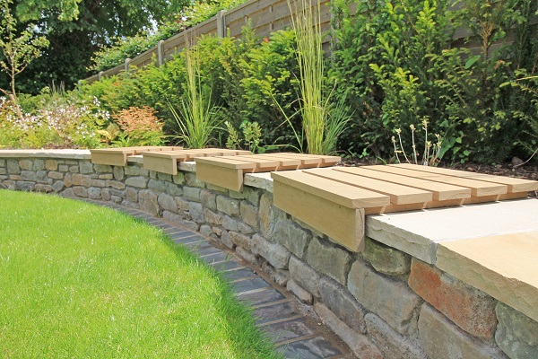 4 Warm Teak composite batten seat tops fitted over curved raised bed to create comfortable seating.