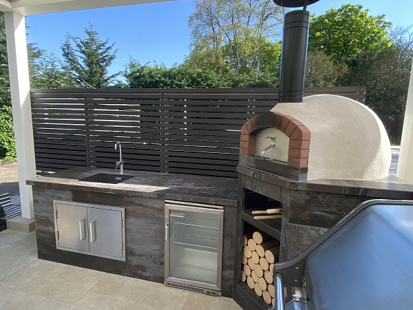 Outdoor kitchen with Dark Ash composite batters as backsplash