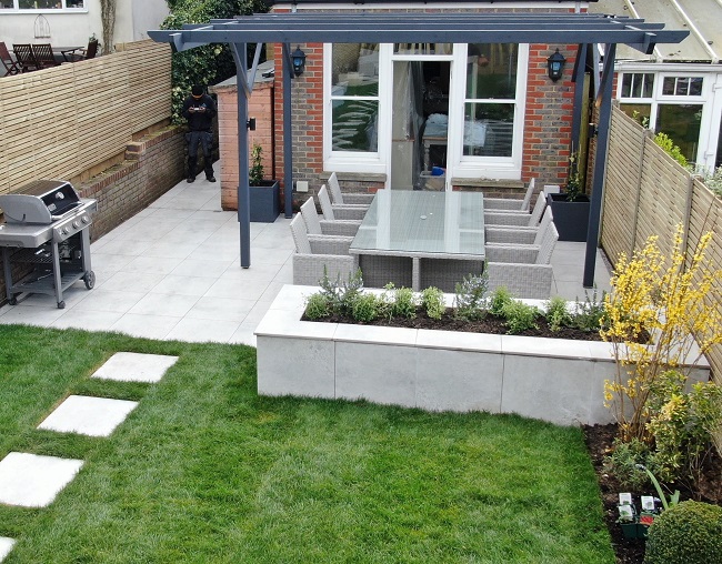 Patio of Light Grey 600x600 porcelain outdoor tiles, also used for stepping stone path in lawn.