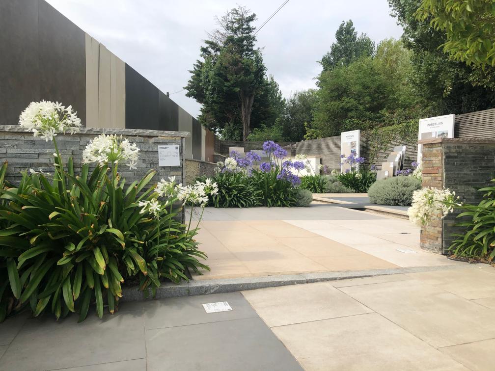 Long paved area with colourful flowers, showing London Stone paving products